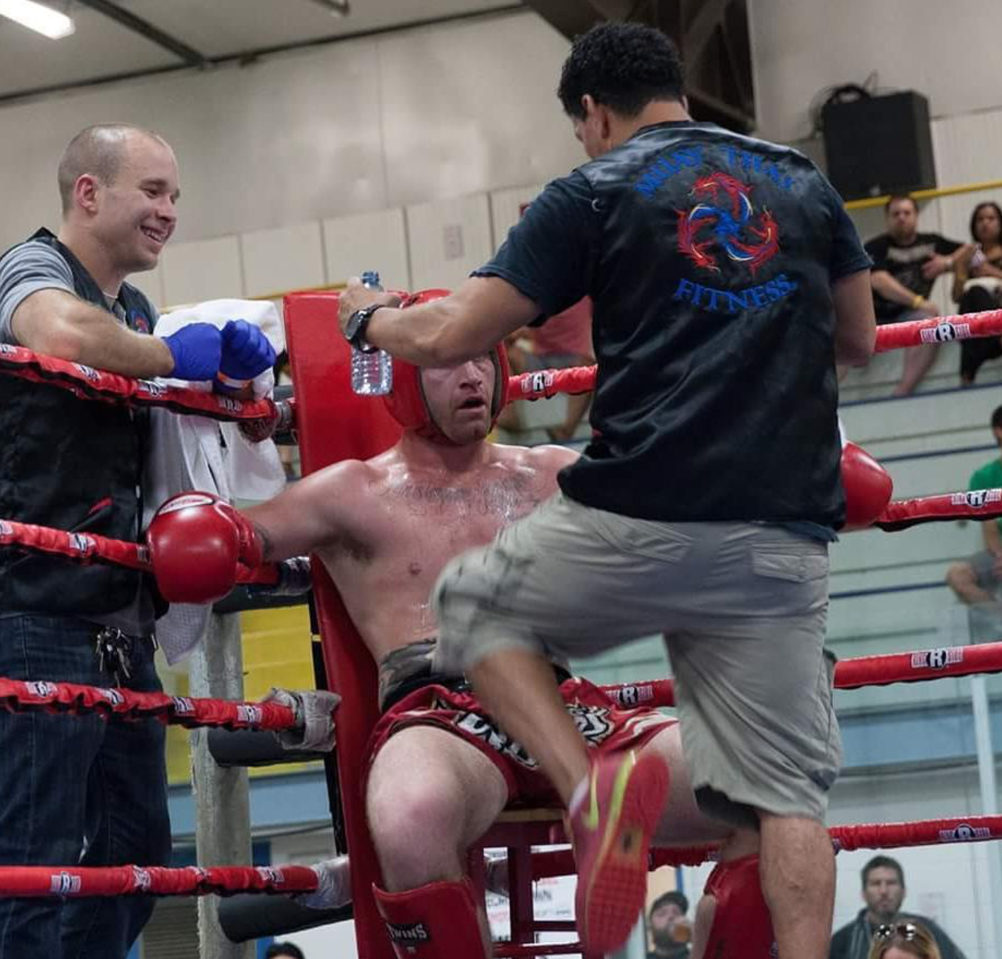 Corner crew tending a Glory fighter between rounds